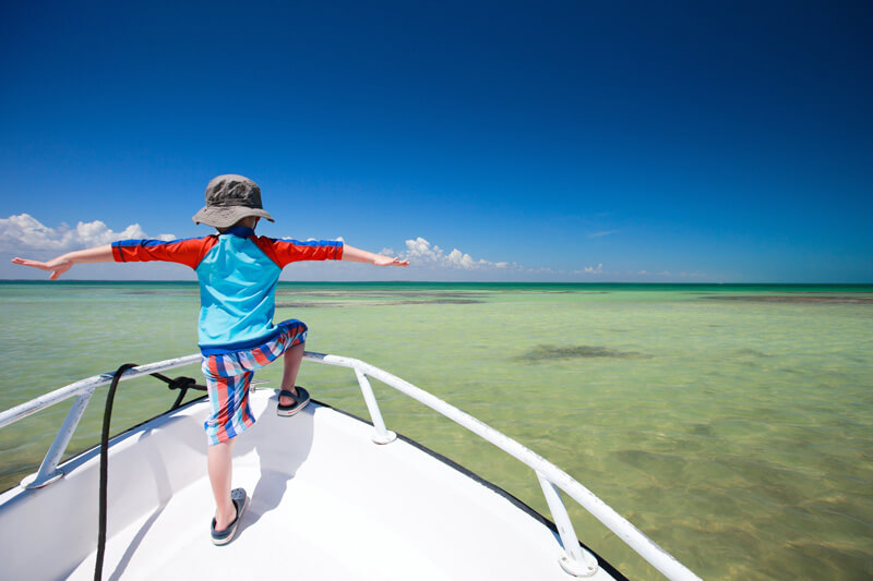 boy on bow of boat