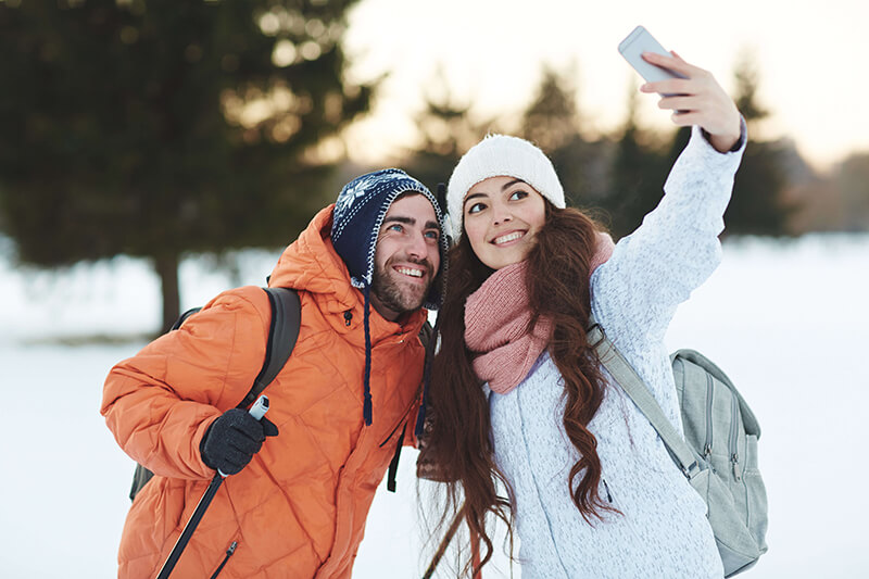couple taking a selfie on ski slopes